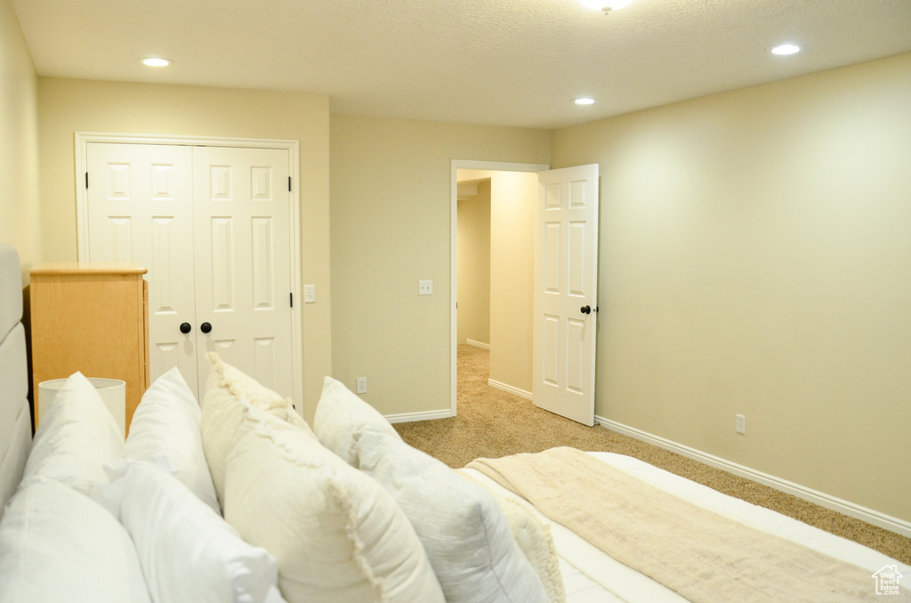 Bedroom with baseboards, carpet flooring, a closet, and recessed lighting