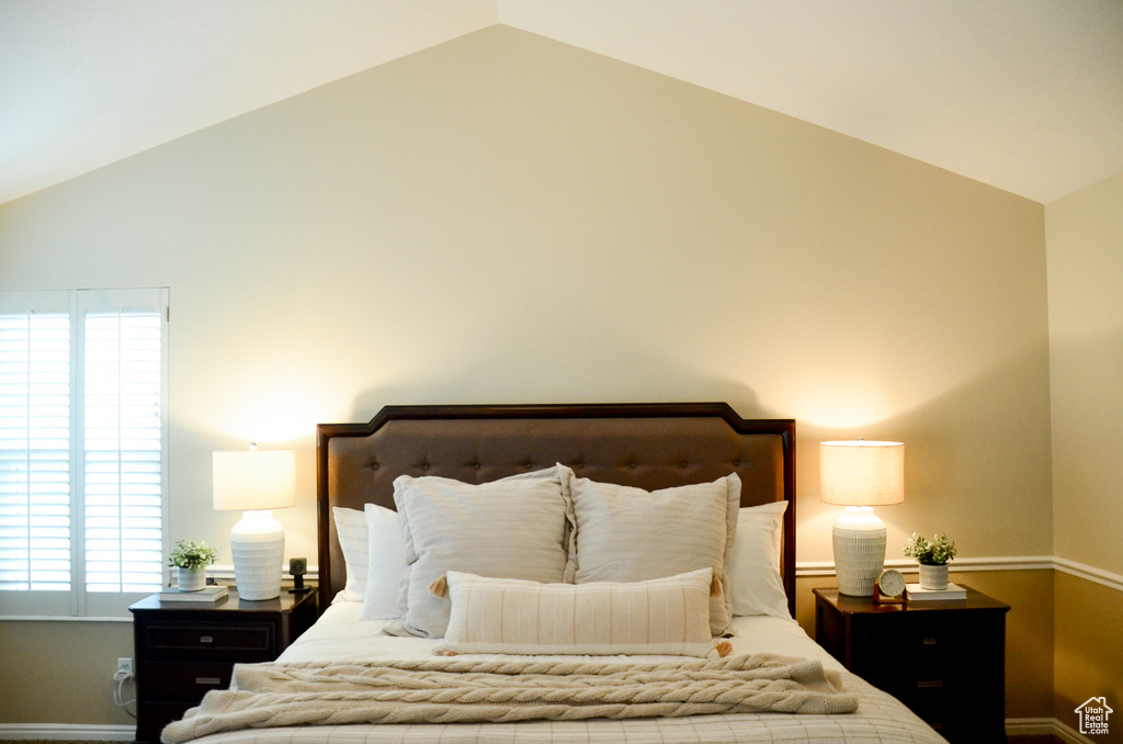 Bedroom featuring vaulted ceiling