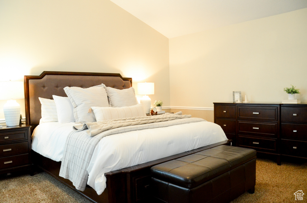 Bedroom with vaulted ceiling and carpet