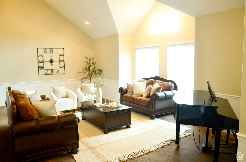 Living area with high vaulted ceiling and recessed lighting