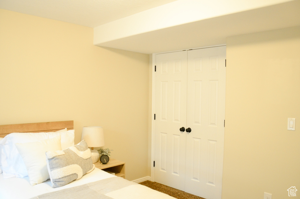 Bedroom featuring carpet and a closet