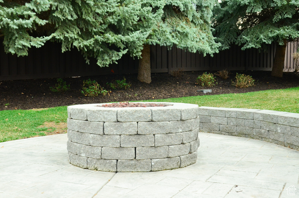 Exterior space featuring a patio area and fence