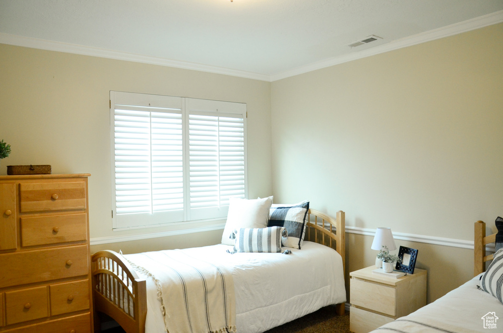 Bedroom featuring crown molding and visible vents