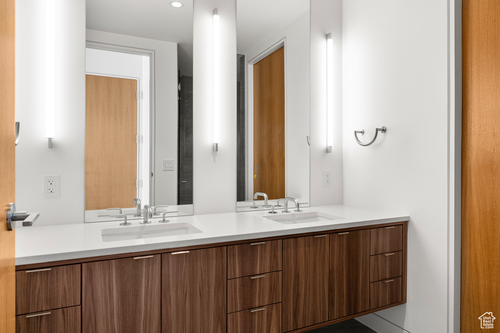 Bathroom featuring double vanity and a sink