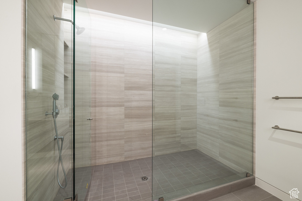Bathroom with a stall shower and tile patterned floors