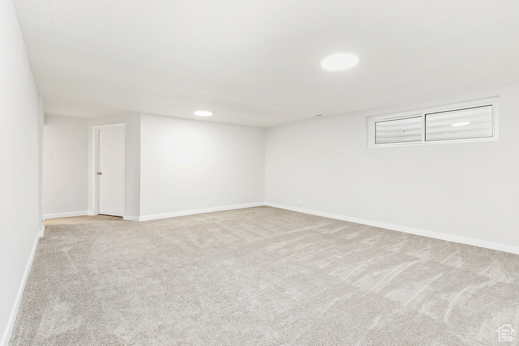 Finished basement featuring carpet floors and baseboards