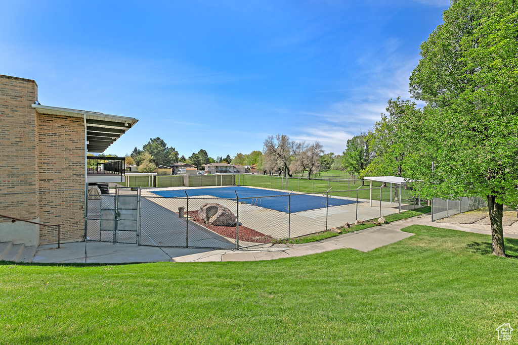 View of pool with a lawn, a gate, fence, and a fenced in pool