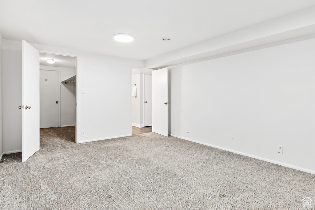 Unfurnished bedroom with baseboards and carpet