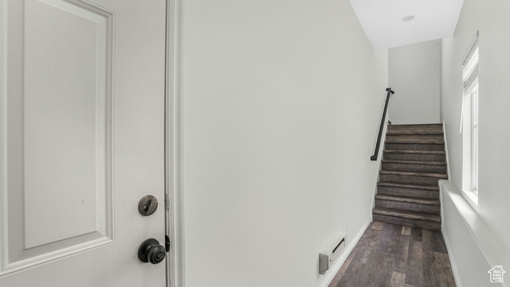 Stairs featuring wood finished floors