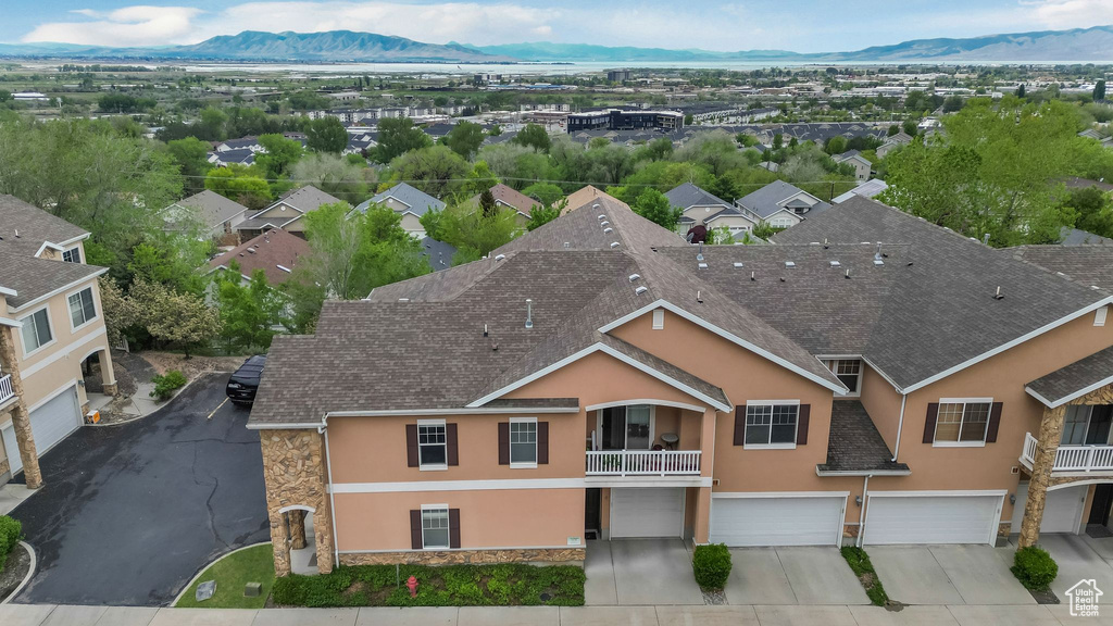Aerial view of property and surrounding area with a mountain backdrop