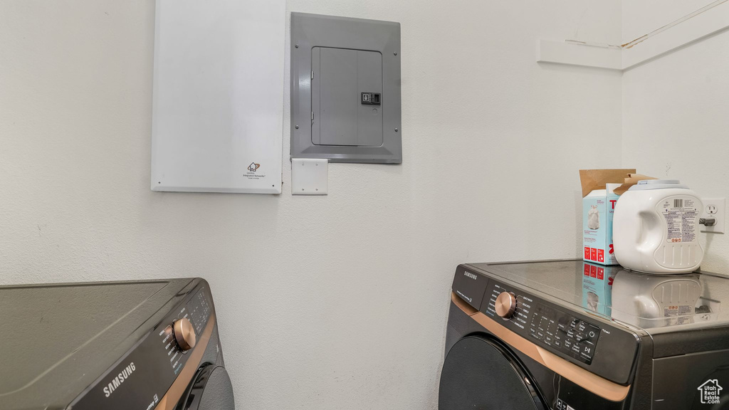Laundry room featuring washer and dryer and electric panel