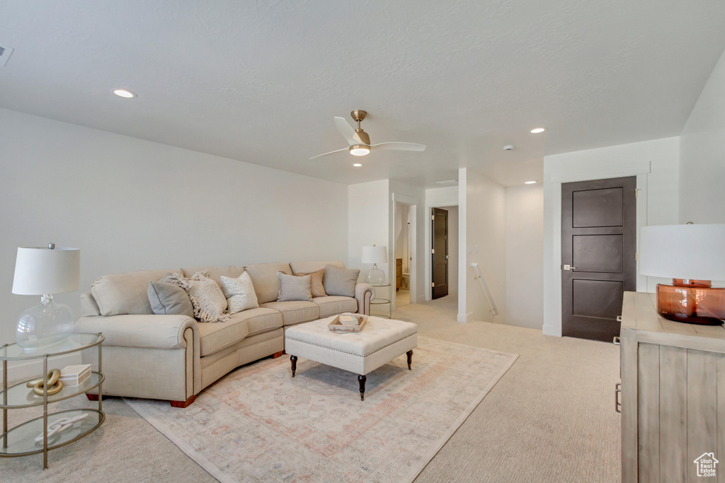 Living room featuring light colored carpet, recessed lighting, and a ceiling fan