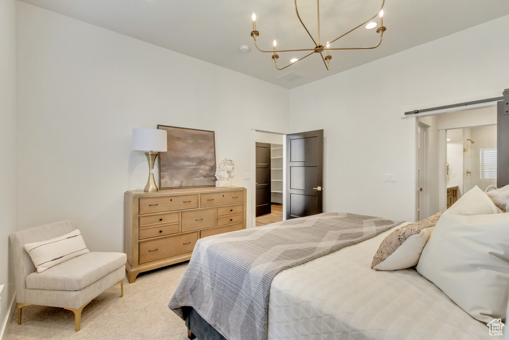 Bedroom featuring light carpet, a notable chandelier, a closet, and a walk in closet