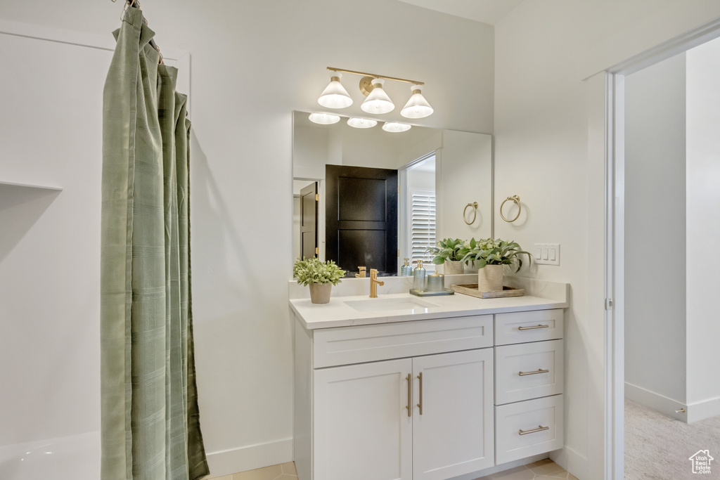 Full bath featuring baseboards and vanity