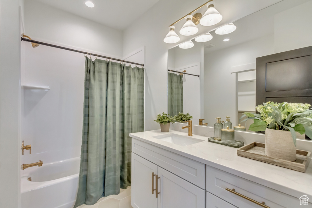 Bathroom featuring recessed lighting, vanity, and shower / bathtub combination with curtain