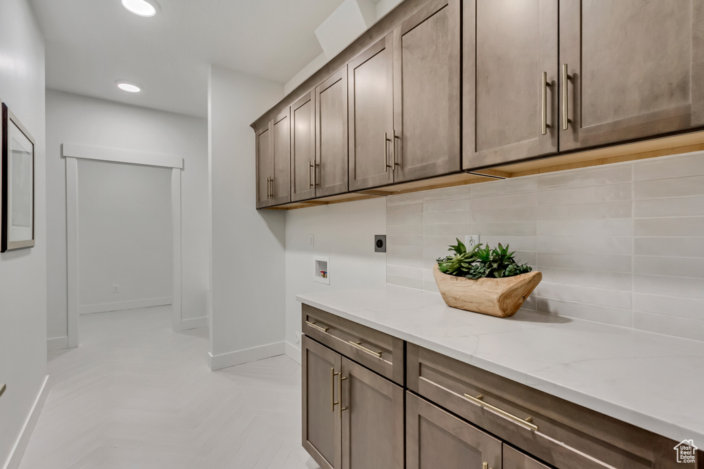 Laundry room with hookup for an electric dryer, baseboards, cabinet space, recessed lighting, and hookup for a washing machine