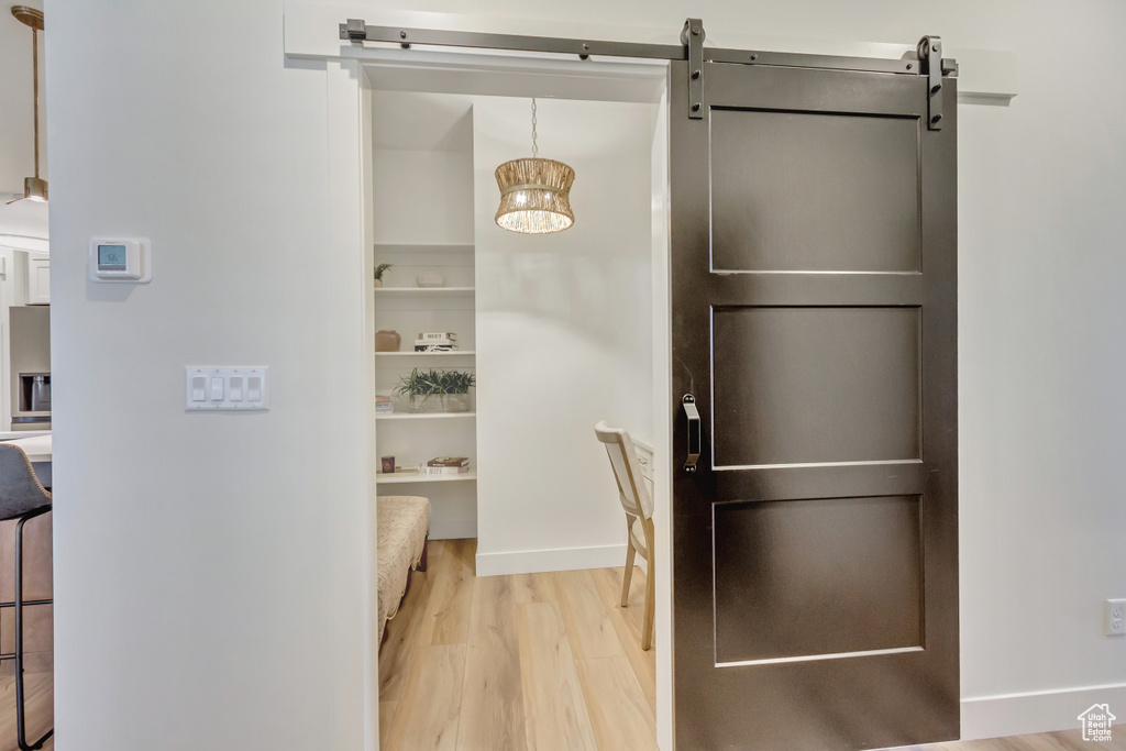 Interior space featuring a barn door and light wood finished floors
