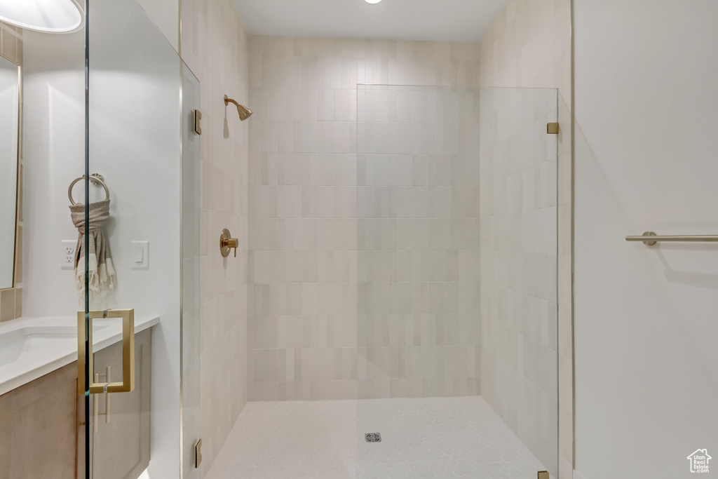 Bathroom with a tile shower and vanity