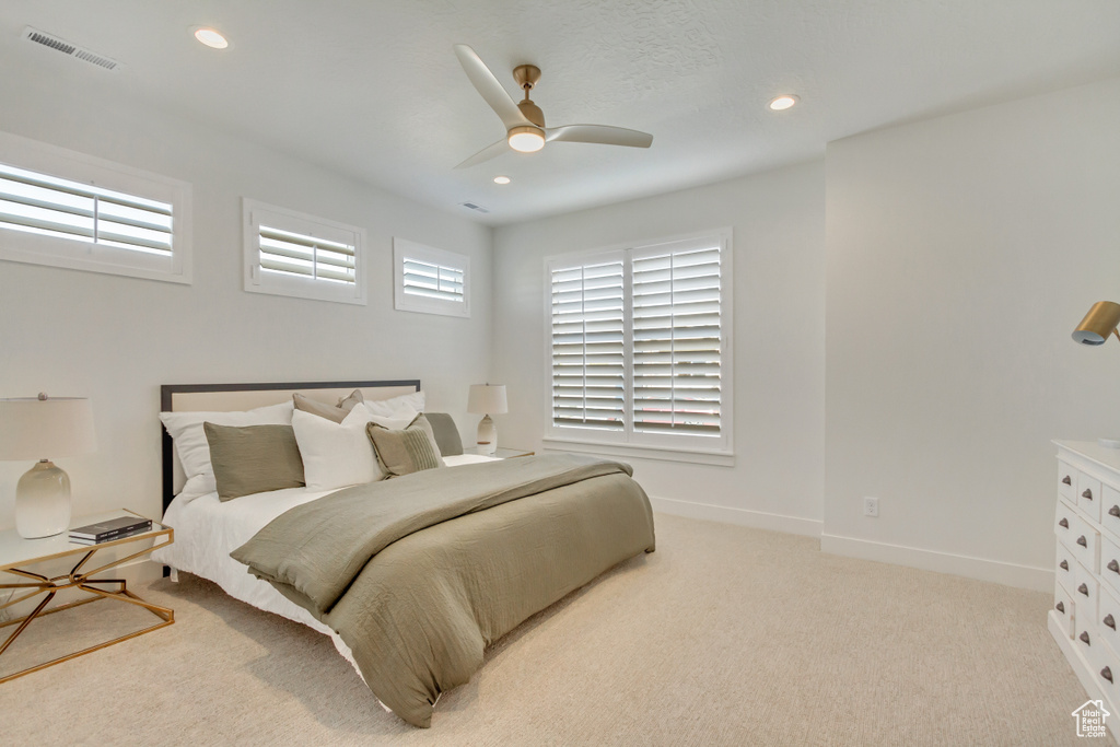 Bedroom with light carpet, baseboards, visible vents, ceiling fan, and recessed lighting