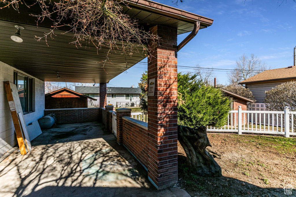 View of patio featuring fence
