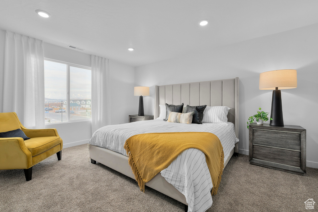 Carpeted bedroom with baseboards, visible vents, and recessed lighting