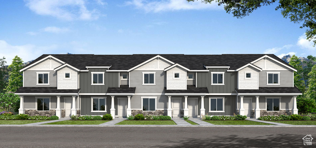 View of front facade featuring stone siding and board and batten siding