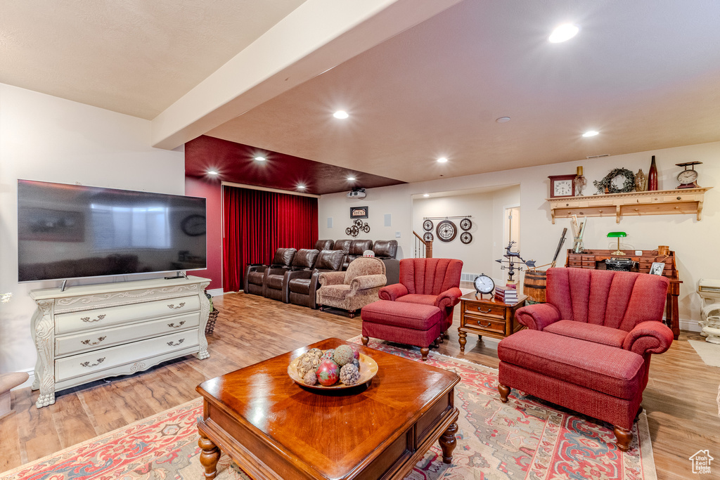 Living area featuring light wood finished floors and recessed lighting