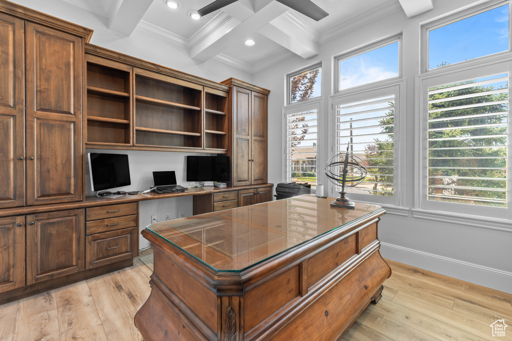 Office space with beam ceiling, light wood-style floors, crown molding, built in desk, and recessed lighting