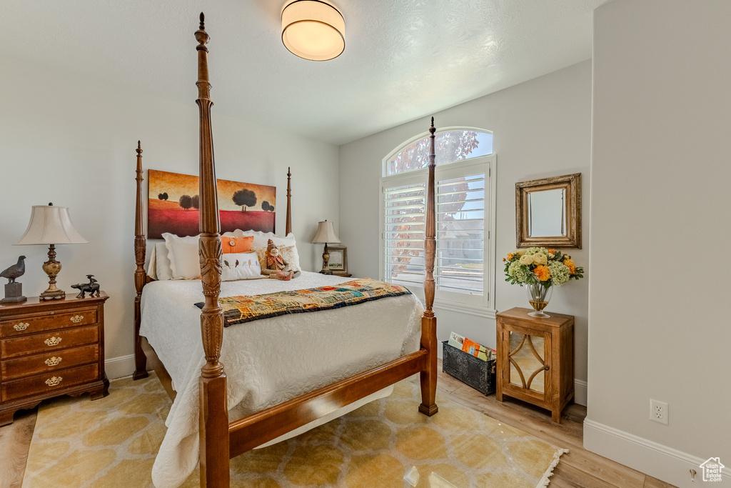 Bedroom with baseboards and wood finished floors