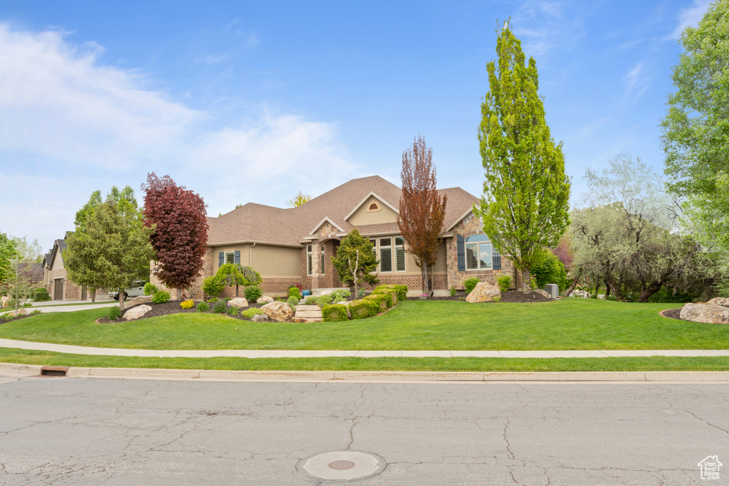 Craftsman inspired home with a front lawn and stone siding