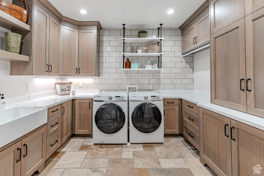 Laundry area with cabinet space, stone finish floor, recessed lighting, and washer and clothes dryer
