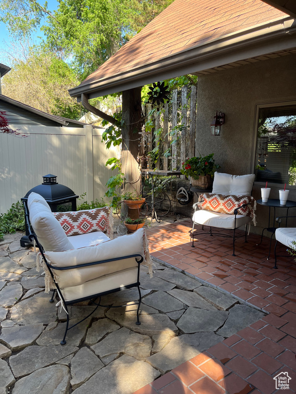 View of patio with an outdoor hangout area and a grill