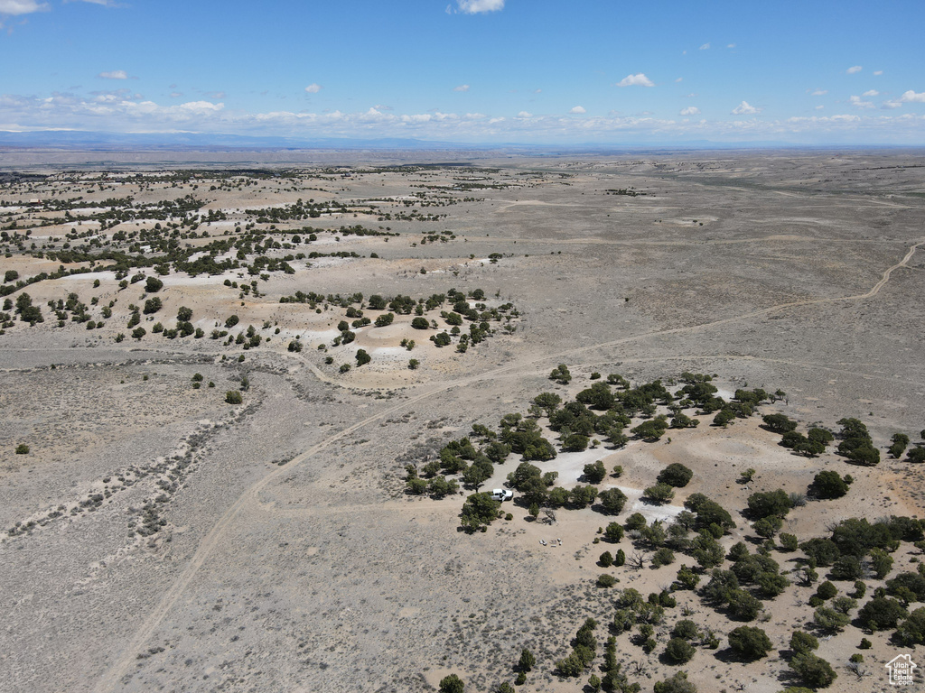 Birds eye view of property with a desert view and a rural view