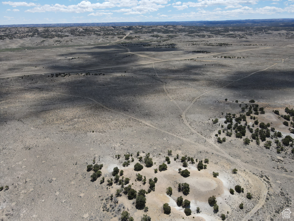 Drone / aerial view featuring view of desert and a rural view