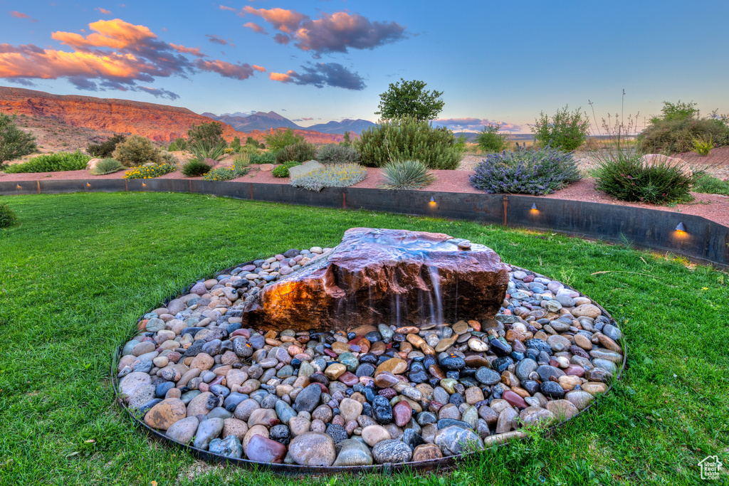 View of green lawn featuring a mountain view