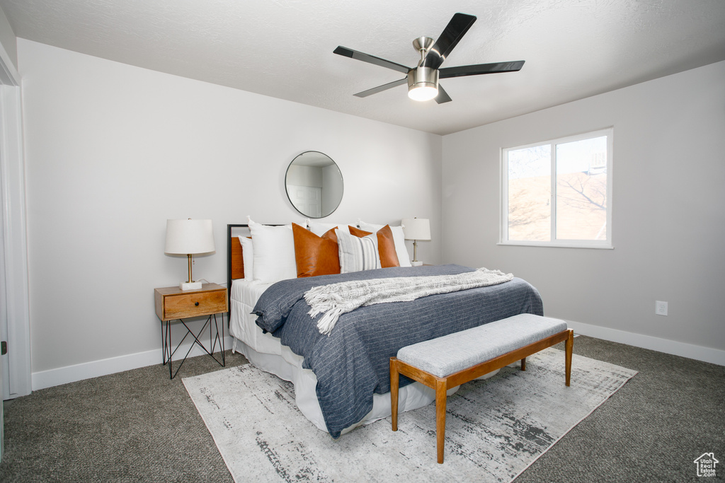 Bedroom with baseboards, ceiling fan, and carpet flooring