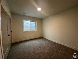 Unfurnished bedroom featuring baseboards and carpet floors