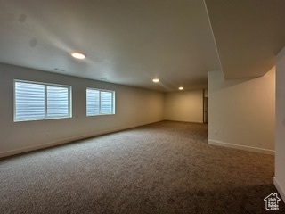 Below grade area with baseboards and carpet