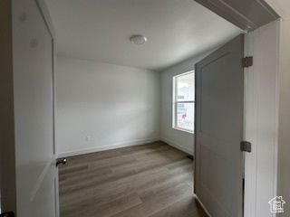 Unfurnished room featuring baseboards and wood finished floors