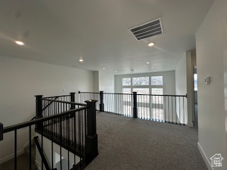 Hall featuring carpet flooring, recessed lighting, baseboards, and visible vents