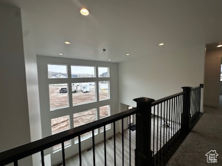 Hall featuring an upstairs landing and recessed lighting