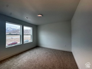 Unfurnished room with baseboards and carpet floors