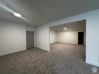 Finished below grade area featuring baseboards and carpet
