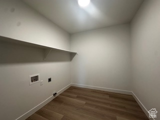 Washroom with washer hookup, baseboards, electric dryer hookup, laundry area, and wood finished floors