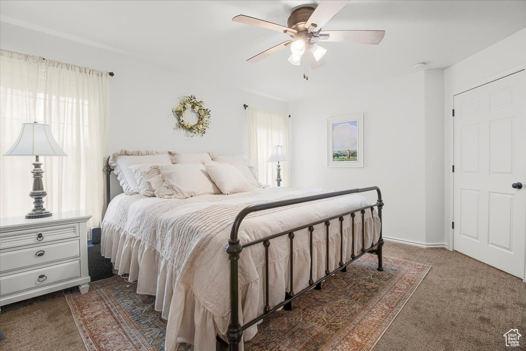 Bedroom featuring a ceiling fan and carpet floors