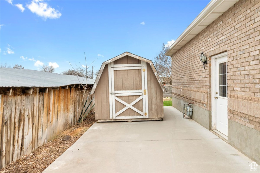 View of shed featuring fence