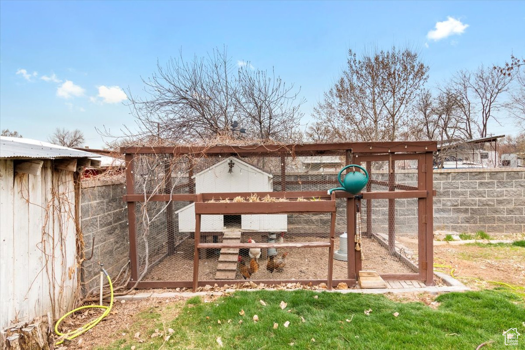 View of yard with fence, exterior structure, and an outdoor structure