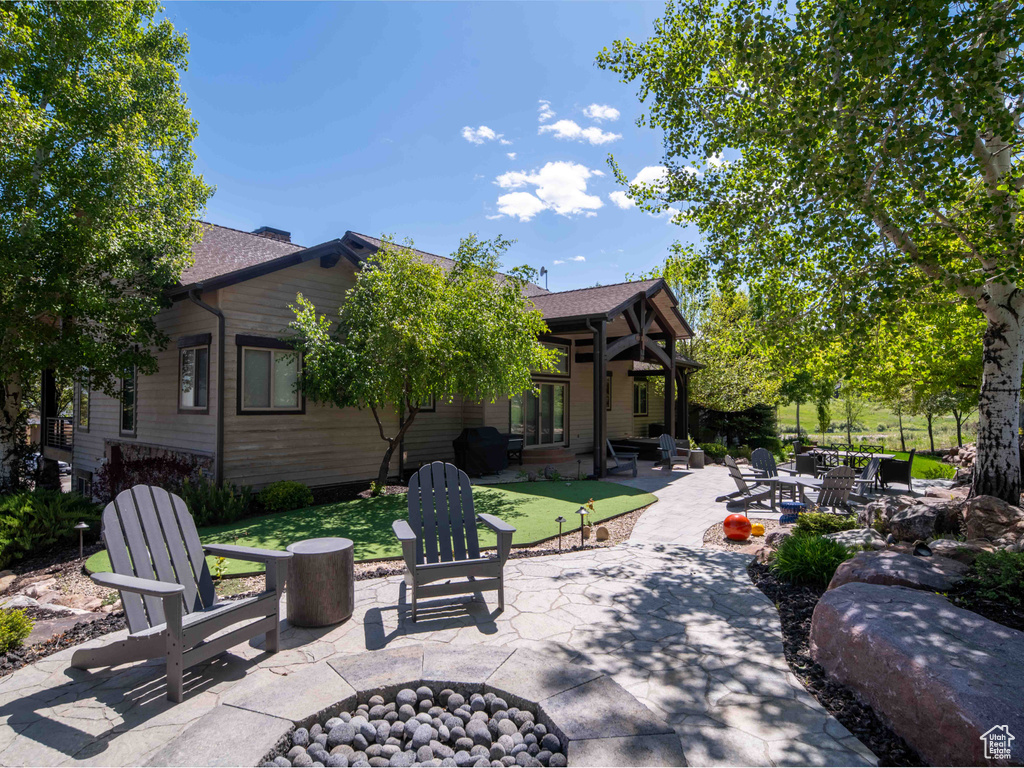View of patio with a fire pit