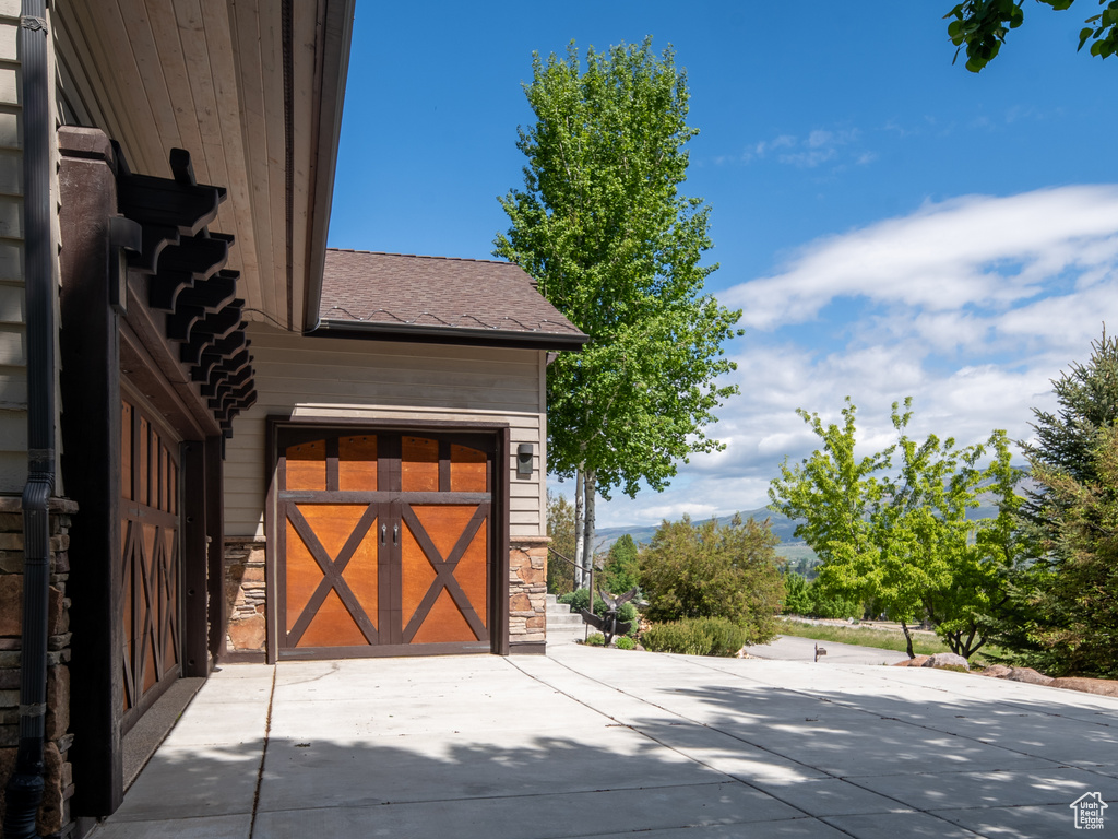 View of patio / terrace featuring driveway and an attached garage