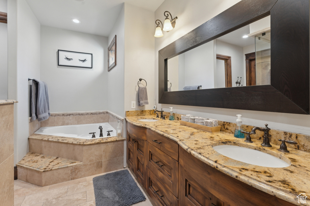 Full bath with a bath, double vanity, and recessed lighting
